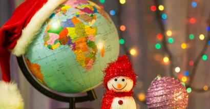 Globe with a Christmas hat and a festive snowman for Christmas activities in humanities